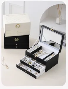 Multi-layer leather jewelry box with mirror, drawers and ring slots for home organization.