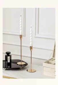Nordic luxury gold candlestick holder detail view with elegant white spiral candle setup