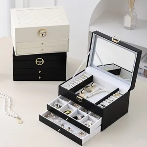 Multi-layer leather jewelry box with mirror, large capacity storage for rings and necklaces.