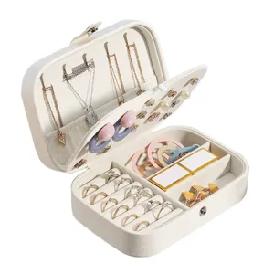 Portable travel jewelry box with multiple compartments for rings, earrings, and necklaces securely.