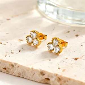 Exquisite stainless steel gold-plated earrings featuring white cubic zirconia heart stones, detail shot.