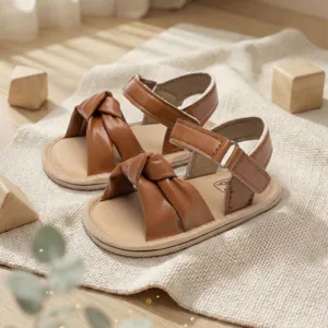 Comfortable brown baby sandals with cute knot design and secure velcro strap for toddlers.