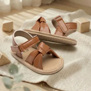 Comfortable brown baby sandals with knot design and velcro strap for infant toddler daily wear.