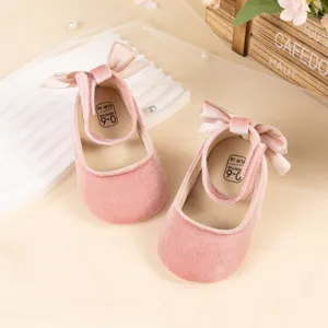 Pink velvet baby princess shoes detail showing soft bow and insole size 0-6 months baby