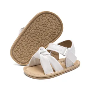 Comfortable white baby sandals with cute bow design and anti-slip rubber sole for toddlers.