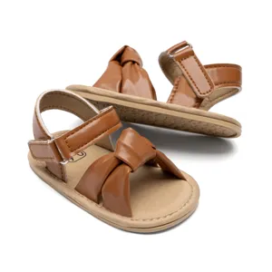 Cute brown baby toddler sandals with knot design, comfortable anti-slip soft sole shoes for infants.