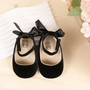 Black velvet baby shoes with cute bow and ankle strap, soft sole for infant prewalkers 0-6m