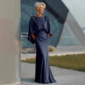 Close-up view of the pleated high waist and elegant fabric drape in an outdoor setting.