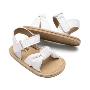 White baby sandals with cute bow, breathable and anti-slip sole for toddlers, cozy fit.