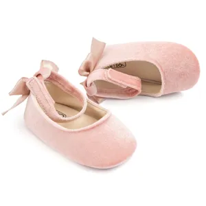 Pink velvet baby shoes for infant girls, soft sole toddler princess shoes with sweet bow decor.
