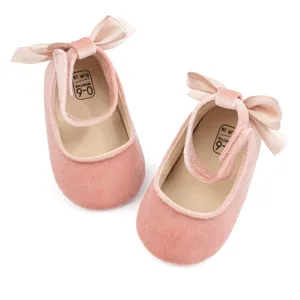 Pink velvet baby princess shoes featuring cute bow and soft sole for infant toddlers.