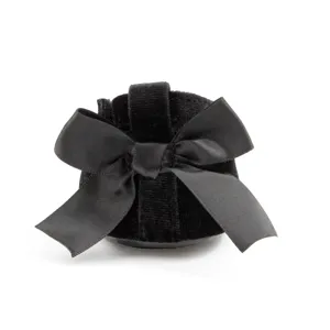 Detailed view of black velvet baby pre-walker shoe showcasing large satin bow on heel.