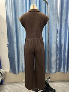 Detailed view of women's sleeveless brown jumpsuit featuring back smocked wide leg styling.