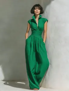 Detail shot of a solid green sleeveless linen jumpsuit featuring high waist and wide legs.
