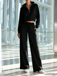 Detailed view of women casual black half-zip crop sweatshirt and wide-leg pants outfit.