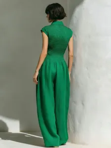 Back view detail of a green sleeveless high waist wide leg jumpsuit, elegant vacation wear.