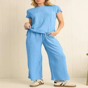 Detailed view of the casual ribbed short-sleeve top and high-waisted wide-leg trousers.