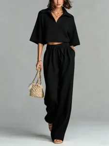 Black hollow knit two piece set featuring polo crop top and high waist wide leg pants.