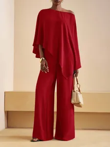 Red off-shoulder asymmetric top and wide-leg pants set detail showing elegant style.