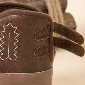 Bottes de cowboy pour bébé en cuir PU marron avec broderie délicate et fermeture velcro.