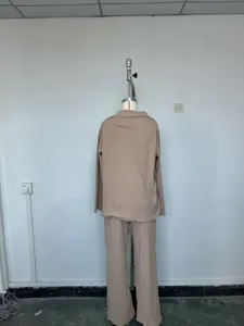 Back detail view of the solid color casual polo sweater and wide leg pants outfit.