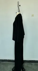 Detail view of the black solid color polo pullover and wide leg pants set, autumn winter style.