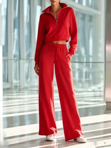 Women's red half-zip cropped sweatshirt and casual wide-leg pants two-piece set.