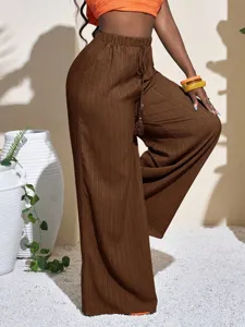 Textured wide-leg pants featuring a high waist and comfortable drawstring design for casual wear.