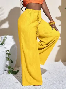 Textured wide leg pants detail view, high waist drawstring design, relaxed fit beach style.