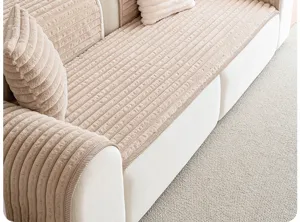 Plush corduroy sofa cover detail, warm cream winter cushion texture, cozy home decor close up