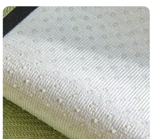 Detail view of the anti-slip silicone dot backing on a summer cooling sofa mat fabric.