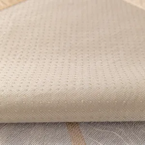 Close-up of beige anti-slip sofa cushion fabric with silicone dotted texture design.