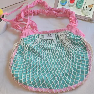 Pink green mesh shoulder crossbody bag, casual dopamine style net tote bag with drawstring detail.