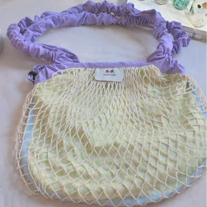 Spring new nylon grid shoulder crossbody drawstring dopamine bag with purple straps.