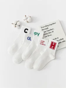 Detail view of white casual mid-calf cotton socks featuring stylish embroidered letters and clean design.