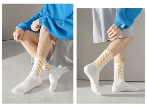 Men white cotton mid-calf sports socks with yellow diagonal stripes and stylish print detail.