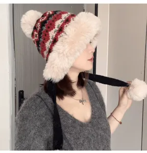 Cozy winter fleece knitted trapper hat with warm earflaps and cute pom pom details.