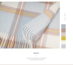 Detailed shot of the classic plaid cashmere scarf with soft fringes and elegant autumn colors.