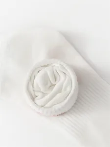 Close up of white cotton men crew socks featuring soft texture and clean minimalist style detail.