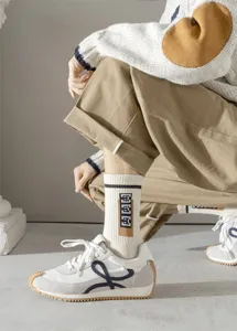 Gros plan de chaussettes mi-hautes blanches pour hommes en coton, motif rétro, stylées.