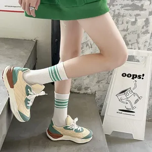 Green stripe mid-tube socks and trendy casual sports sneakers for daily streetwear styling.