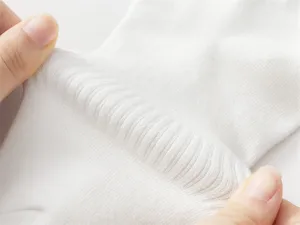 Close-up shot of white cotton men's socks showing soft fabric texture and great elasticity.