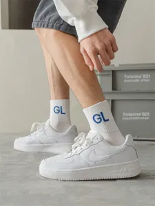 Men stylish white mid-tube cotton sports socks featuring trendy blue letter embroidery design.