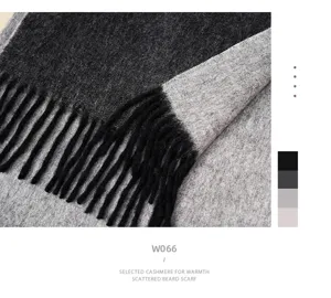 Close-up view of the double-sided cashmere scarf showing texture, fringe, and color details.