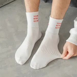 Men's white mid-tube cotton socks with red letter embroidery, casual streetwear trend.