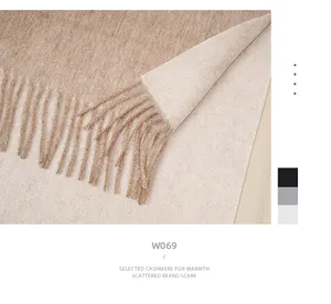 Close-up detail of the women's double-sided knitted scarf featuring elegant tassels and soft wool texture.