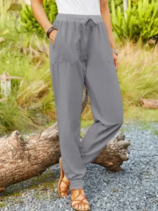 Casual grey cotton linen trousers detail shot featuring elastic drawstring waist and side pockets.