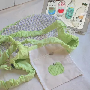 Green mesh nylon shoulder crossbody bag with purple plaid lining and cute apple pouch.