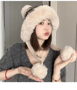 Close-up of fluffy winter plush ushanka hat with cute pom-poms, soft warm ear flaps detail.