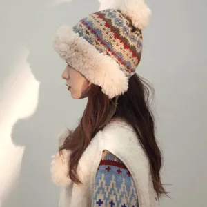 Side view of a cozy winter plush knit hat with fluffy pom-pom and warm fur lining for women.